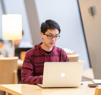 A student working on a computer preparing for careers in computer science.